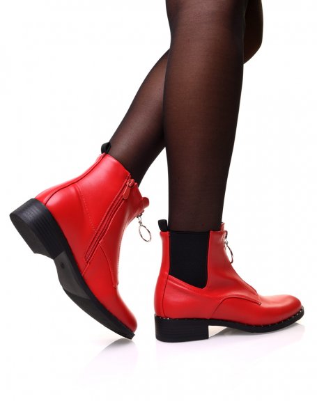 Red ankle boots with studded sole and decorative zipper at the front