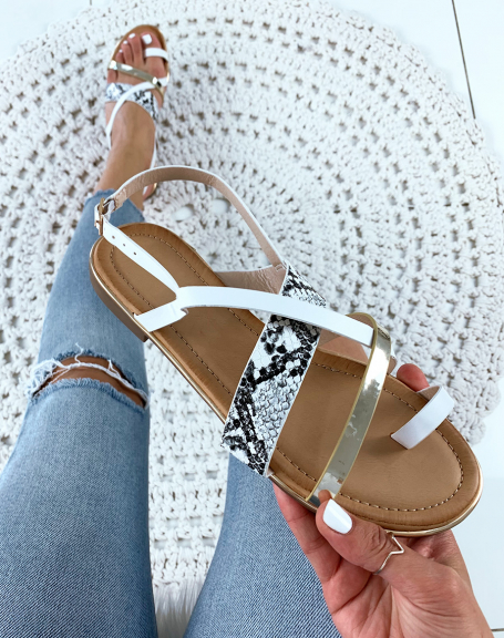 Sandals with multiple crisscrossed white gold straps and python effect