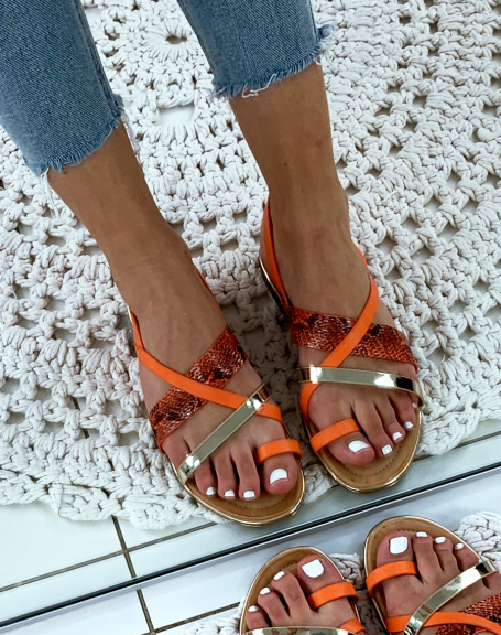 Slippers with multiple crisscrossing golden orange and python-effect straps