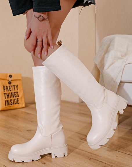 Tall beige boots with notched sole