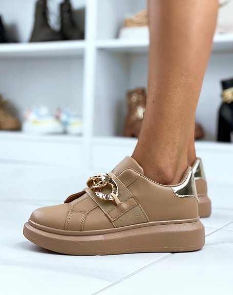 Taupe sneakers adorned with a golden chain