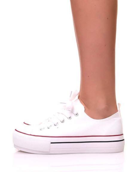 White canvas sneakers with platforms decorated with trims