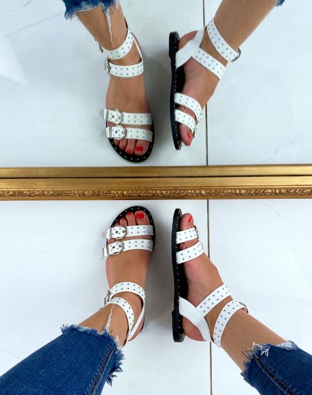 White flat sandals with small studs and adjustable straps
