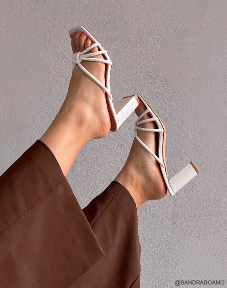 White heeled mules with criss-cross straps