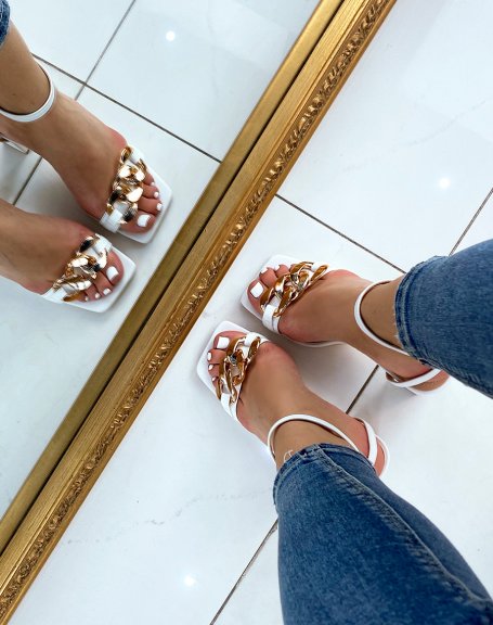 White heeled sandals with thin straps and gold chain