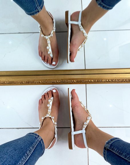 White sandals decorated with white pearls