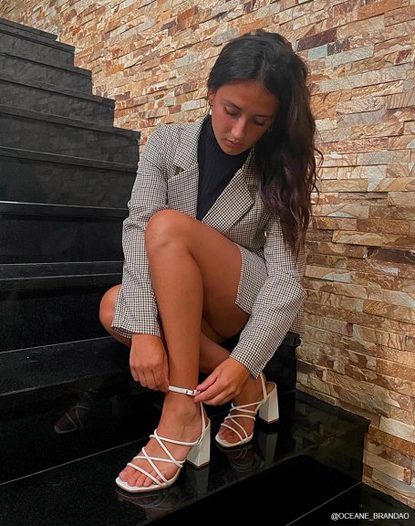 White sandals with criss-cross straps and thick heel