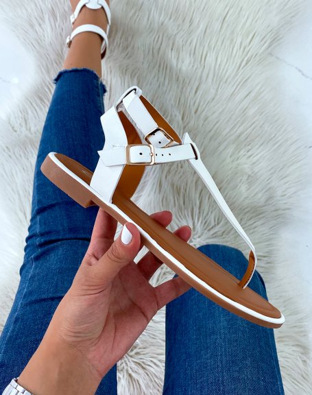 White sandals with double strap and golden buckles