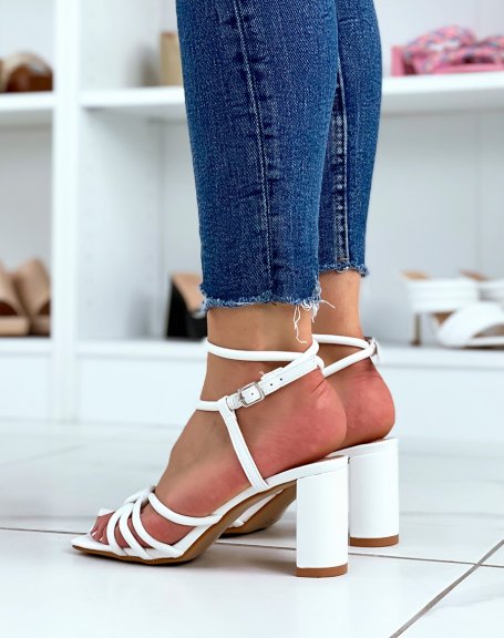 White sandals with high straps and tied heel