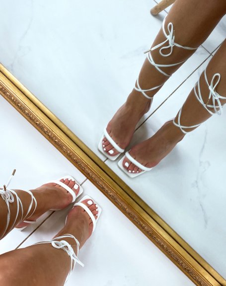 White sandals with laces and thin strap heel