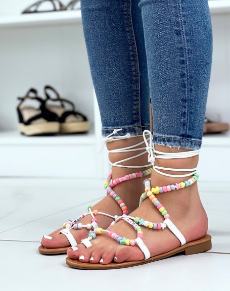 White sandals with long straps with colored beads