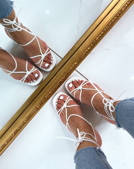 White sandals with low heel and multiple straps