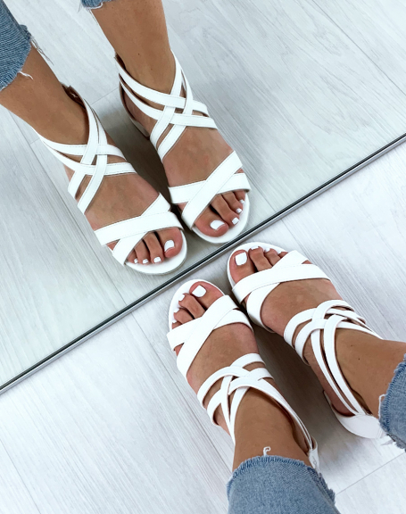 White sandals with multiple crossed straps