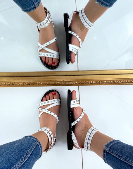 White sandals with multiple studded criss-cross straps