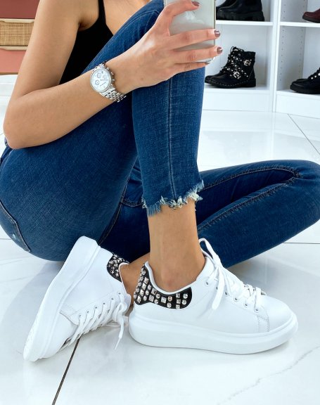 White sneakers with black and studded yoke
