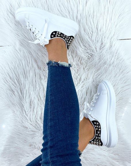 White sneakers with black and studded yoke