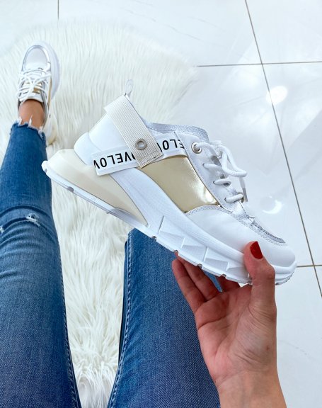 White sneakers with multiple panels and fancy sole