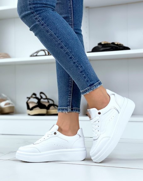 White sneakers with silver edging and thick sole