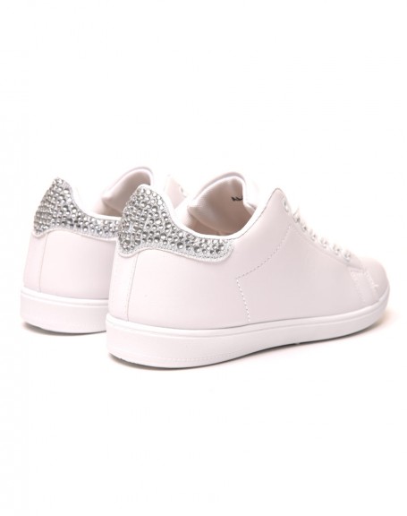 White sneakers with silver rhinestone details on the back