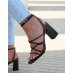 Black sandals with criss-cross straps and thick heel