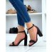 Black sandals with rounded strap and high heel