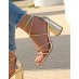 Golden sandals with intersecting straps and rounded heel